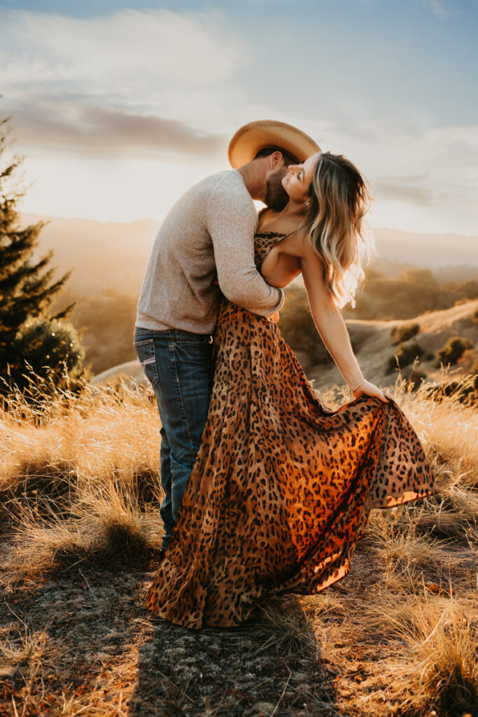 Family Photography, Couple in a field man kissing womans neck